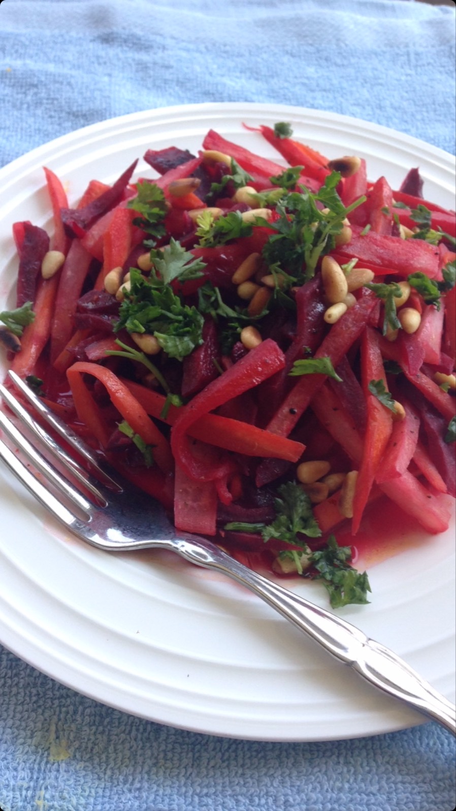 #beets#salad#Daikon#This salad is very colorful and tasty. Beetroots have wonderful health benefits, and although they may not sound good, they taste delicious in this salad!
 
1/4 cup pine nuts
4 oz Daikon - peeled (mooli)
4 oz beet roots
4 oz carrot - peeled
⅓ cup orange juice or ½ cup fresh orange juice
1 tbsp coriander leaves 
Method
Take a non-stick pan, and put on the gas with pine nuts.
Roast on medium high heat for 2 minutes or until golden brown.
Put the pine nuts on another plate and keep aside.
Take a sharp knife and cut the mooli, beetroot, and carrots into long strips.
Take a pan and add oil. Add each vegetable separately and stir fry for about 2-3 minutes.
Take a big bowl and mix the vegetables, salt, and pepper.
Now, add orange juice, followed by the coriander leaves and pine nuts.
Enjoy!