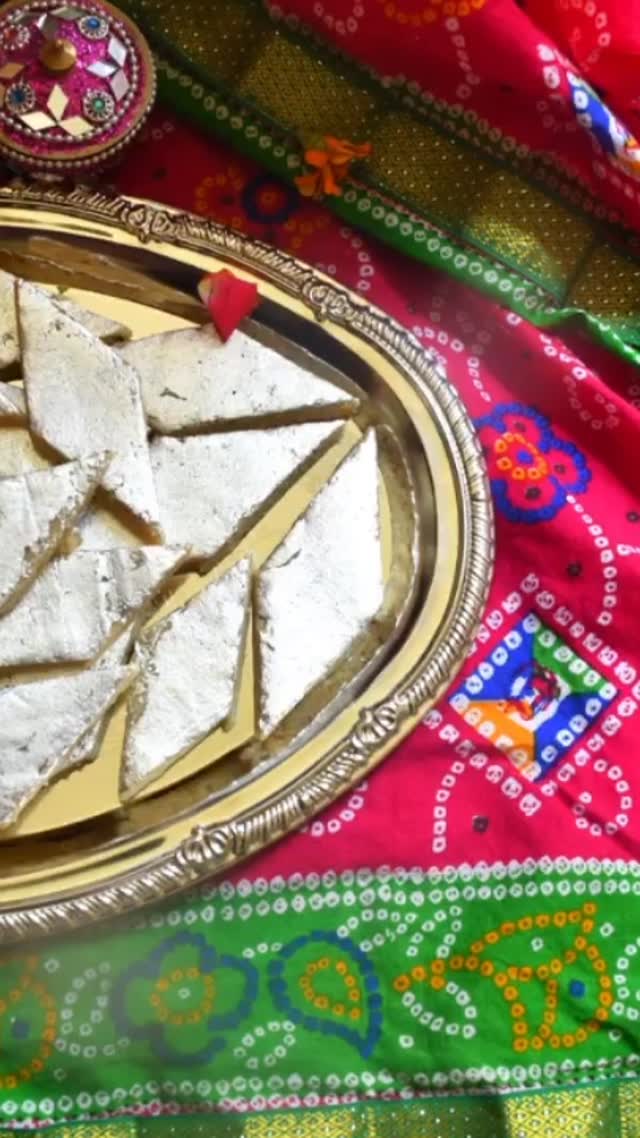 #kajukatli #kaju❤️ #sweet#fancy#Kaju (Cashewnut) Katli is probably the most popular sweets in India. It is the most bought and gifted sweets during festival season and for other occasions. People always admire it if you serve or give a gift of Kaju Katli . General thinking is that kaju katli is difficult  to make at home but surprisingly it is very quick and easy to make. Just follow my recipe step by step and you can make Kaju katli that tastes and looks similar to that sold at large sweet shops. No one will believe that it is homemade.
 
Ingredients:
Make 500 gm.

250 gm Kajus (Full or split or broken)
50 gm. milk powder
160 gm. Sugar
100 ml water
Saffron (optional)
Edible silver/  chandi varak (Optional for garnish)
One thick plastic sheet, or parchment paper for rolling 

Method:
Place Kajus, about 1/2 cup at a time, in the food processor. Pulse until you reach a flour-like consistency; sift into a container. Place any remaining Kaju chunks back into the food processor and pulse. Repeat until all Kajus are transformed into flour. Make sure you do not pulse too much else Kajus will release fat making it non suitable for the recipe.. 
Mix Kaju flour and dry milk in a container. 
To prepare sugar syrup, add sugar, water and saffron in a shallow pot and heat on low-medium flame. Heat for about 3 to 5 minutes till large bubbles start rising and you see two threads when you take a drop of syrup and pinch between two fingers and release fingers. Stir often.
Turn off the heat and add Kaju - milk powder mix to the syrup. Mix everything very well so that it becomes like dough. Spread it in the pan and let rest it cool. Dough should be firm and stiff. If it is sticky, add Kaju flour one spoon at a time to make it firm and stiff.
Remove the dough and knead it for about 2-3 minutes by keeping it in between thick plastic sheets. 
Keep the dough between plastic sheet and roll the dough into a flat sheet about ¼ inch thickness (like a big chapati)
Wait for about 5 minutes and garnish with edible silver foil (silver varak) and cut into diamond shapes of desired size.
Keep it in the refrigerator for about an hour for it to set.
Store it in the refrigerator.

Enjoy!