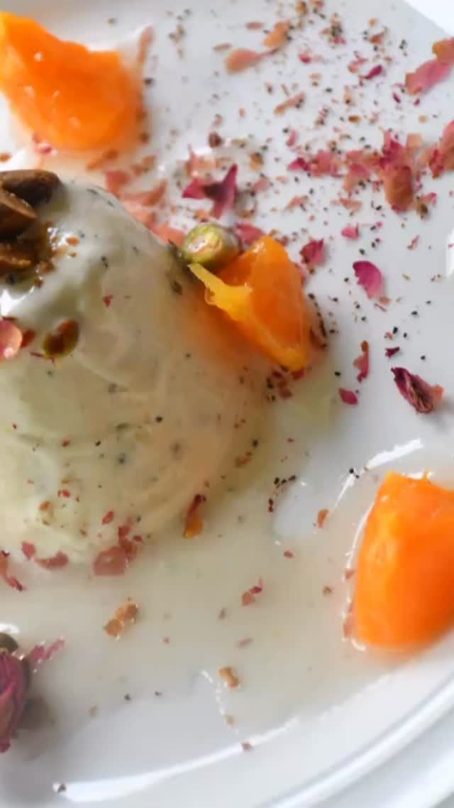 #cardamom ice ram#This dessert is extremely beautiful and elegant, bursting with different flavors like vanilla, cardamom, and rose water. It’s delicious, and perfect for the summer#kulfi#sweet#delicious 

Ingredients:
Serves: 6
2½ cup heavy cream 
1 cup whole milk
1 tsp vanilla essence
2 tsp cardamom powder
⅓ cup sugar
Pinch of salt

For the topping
2 oranges or 1 grapefruit 
⅓ cup sugar
⅓ cup water
1 inch ginger, sliced
½ tsp rose water

Garnish
Roasted pistachios, chopped
Dried rose petals

Method:
Take a heavy fry pan and add milk, cream, and cardamom powder and put on slow heat. 
Let simmer for about 30 minutes or until the milk mixture is halved. 
Add sugar and mix.
Wait until the sugar dissolves, then add vanilla essence and salt. Mix and turn off the heat.
Now wait until the milk mixture comes to room temperature.
Take a mold and add the milk mixture and put in the fridge for about 24 hours.

For the citrus fruit:
Add sugar and water to a pan with sliced ginger and put on medium heat.
Wait until sugar dissolves and syrup thickens slightly.
Strain the syrup and remove the ginger. Keep aside.
Peel the orange or grapefruit cut into pieces and add rose water. Keep aside.
To serve, take a plate and pour sugar syrup onto it. Put the ice cream in the center, and top off pistachio, orange, and rose petals.
Enjoy!