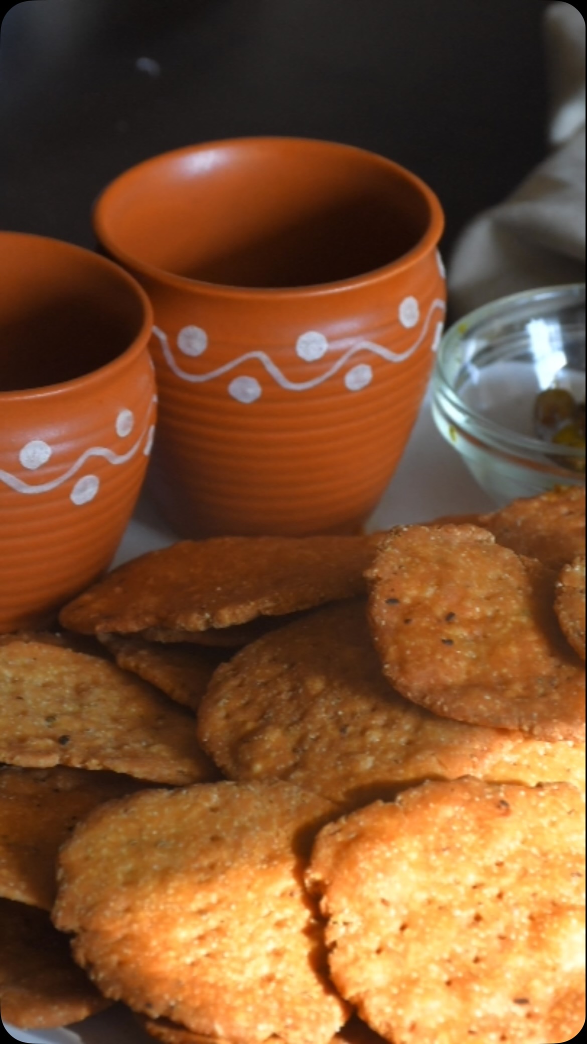 #Matari#indianfoodrecipes #This is a great snack, for tea or coffee.
Ingredients:
Make 12 
1 cup all purpose flour or whole wheat flour 
1/4 cup fine sooji
1/2 tsp salt
2⅓  cup oil or more for frying 
1/2 tsp ajwain
1/2 tsp crushed black pepper

Method:
 
Take a big bowl, and add the flour, salt, ajwain, sooji, & black pepper. Mix everything with a hand. 
Pour 1/3 cup oil in the center and mix 
At this point, a dough should form with which you are able to make small balls when you hold it in your fist. 
Add a little water (2 tbsp) at a time to the mix and knead it and make a hard dough. 
If required, add extra water.  Divide the dough and roll into small spheres with a diameter of about an inch.. 
Roll into small circular flats about 3inch circles using a rolling pin. If it is easier, use a round cookie cutter.
 Make small holes all over each mathri using a fork. Dry the flats on a fabric for 5 to 6 hours. Turn over after about 3 hours. 
Drying is very important as it helps the mathris consume less oil and also makes crispier mathris.
After about 5 hours, pour the rest of the oil in a frying pan and heat on a slow flame. 
To check if the oil is ready, put a small piece of mathri and see if it rises to the top after being put in. 
When the oil is ready, add a few mathris at a time and deep fry until they are brown in color. Matari  are ready to eat.
 You can store these in an airtight coke them out and let them cool on a paper napkin.
Note : add ghee for dough to taste better make matri crispy and tasty 
See more recipes on my cookbook