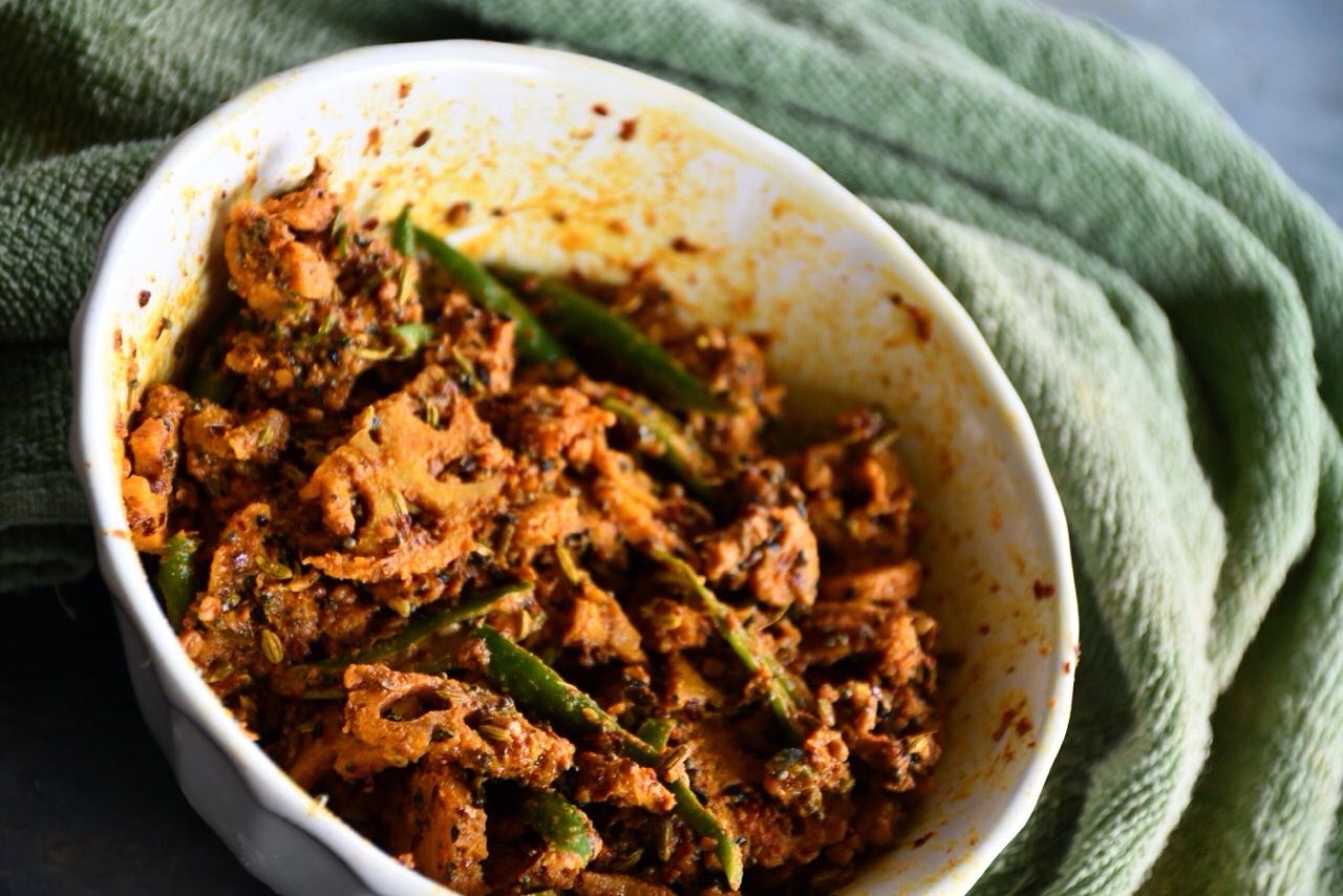 #pickle#achar#It sounds weird to prepare achaar from #kamal kakri (lotus root), but it is really tasty and crunchy in texture.
Lotus roots are consumed as a vegetable in Asian countries, extensively in China, Japan, and India: sold whole or in cut pieces, fresh, frozen or canned. It has crunchy texture with sweet-tangy flavours, These are also promoted have purported diuretic, antidiabetic, and anti-inflammatory properties
Although traditional pickle is not considered healthy, lotus root pickle may give some mental satisfaction that you are eating a healthy vegetablerecipe 👇
Ingredients
Makes 1 medium bowl
1 cup kamal kakri (lotus root) - washed, peeled and cut into small chunks
¼ cup green chili - cut into thin slices
⅓ cup turmeric powder
2 tbsp red chili powder (adjust as per taste)
2 tsp Kashmiri mirch - for color
2 tbsp kalonji (Nigella/ Black seeds)
½ cup mustard oil
3 tsp mustard seeds
2 tbsp methi (fenugreek) seeds
2 tbsp amchoor powder (dried mango powder)
2 tbsp fennel seeds
1 tsp hing powder
⅓ cup salt (adjust as per taste)
Method
Boil water in a pan, add lotus root chunks, take it out after about a minute, strain out the water and keep aside.
Add salt and turmeric powder to the lotus root chunks, mix it and keep for a 1 day. If possible, keep outside in the sunlight.
Drain out any water, and spread the pieces to dry out (for about 5-6 hours).
Dry roast fennel seeds, kalonji seeds, mustard seeds, fenugreek seeds for about 2 minutes on low heat then crush to a coarse powder.
Heat oil on low heat and add hing. Wait for 10 to 15 second.
Now, Mix lotus root chunks, green chilli, roasted spices, other spices and oil. Transfer to a jar. Cover and keep in the sunlight for 3-4 days.
Enjoy !