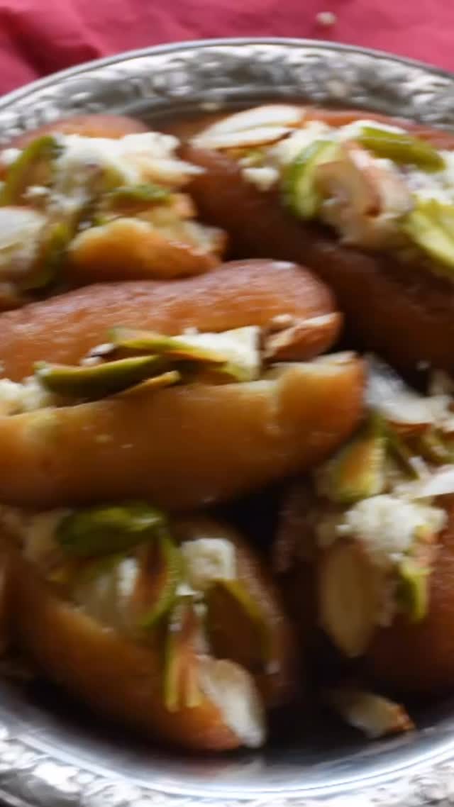 #sandwich #gulabjamun #sweet#Gulab Jamun are the ‘go to’ sweet dish in South Asian countries and Gaulab Jamun sandwich is the fancier and better tasting version of the popular gumal jamuns. It is a very elegant and tasty gulab jamun dish. When you look at it and taste it, it seems difficult to make. But, believe me and believe yourself, when you start the recipe, it is not too difficult and the end result is worth the effort. Nothing is  too hard in cooking. Make sure to follow the recipe step by step and make the dish. It is made of Khoya, paneer and sugar#recipe on my website. 

Ingredients 
Makes 10 Gulab Jamun Sandwiches 
For gulab jamun 
1½ cup khoya - roasted ( 1 cup for gulab jamun and  ½ cup for stuffing) 
⅓ cup paneer 
2 tbsp all purpose flour
2 tbsp sugar
¼ tsp baking soda
Oil for frying
1 tsp cardamom powder
Pistachio and almonds - sliced (for garnishing)
For syrup 
2 cup sugar 
2 cup water 
1 tbsp lemon juice 
Few flakes of saffron