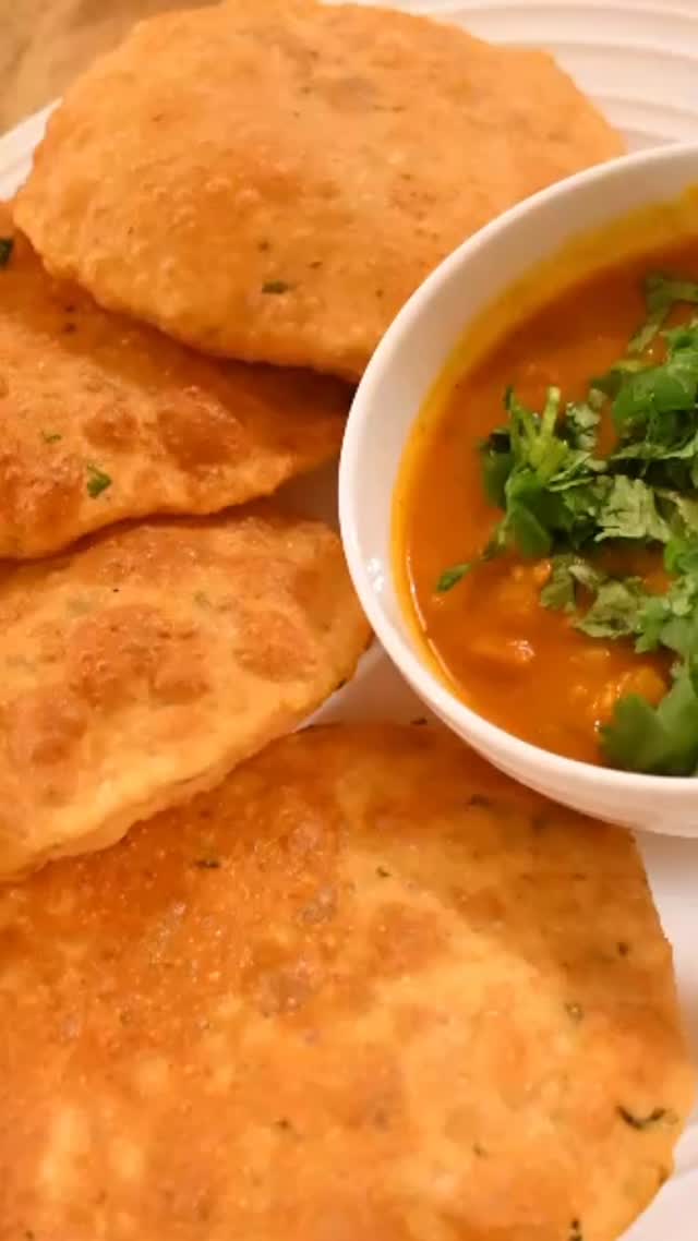 #Bedmi poori with #aloo (potato) ki sabji is a popular restaurant/ street breakfast item  in northern India especially in  U.P. This is a complete dish that can be served anytime and not just breakfast i.e. for  brunch,lunch or dinner. It requires little preparation and when you serve, you realize it was all worth the effort#recipeonmywebsite 

INGREDIENTS
Serves: 6 

Aloo (Potato)  ki sabji
2 pound Potato boiled and cut into small pieces.
2 medium tomato puree 
 2 tbsp oil 
2 tbsp turmeric powder 
2 tsp besan ( chickpea flour)
2 green chili finely chopped 
½ cup dahi (yogurt) beaten 
½ tsp hing (asafoetida)
½ tsp cumin seed 
1 tsp kashmiri red chilli powder or to taste 
1 tsp amchoor powder
1 tsp chaat masala powder 
salt to taste 

Dough
1 cup urad dal, rinsed and soaked for about 5 hours
3 cup whole wheat flour 
1/2  cup suji
salt to taste 
1 tsp red chilli powder or to tasting 
1 tbsp coriander leaves (optional)
oil for frying 

For curry 
Take a wok and add oil,  add cumin seeds and hing when oil gets heated.
Wait until cumin seeds crackle. 
Add turmeric powder,  stir and then add kashmiri red chilli powder.
Add basen and stir for about 2 minutes. 
Add tomato puree, garam Masala, coriander powder, green chilly, amchoor powder, chaat masala with red chilli powder. Keep 
stirring for about a minutes 
Now add potatoes (Boiled and cut). 
mix and add about 2 cups of water or more to make thick gravy. 
Add yogurt and stir.
Cover the lid for about 8 - 10 minutes on medium heat. Stir in between.
Garnish with fresh coriander leaves.