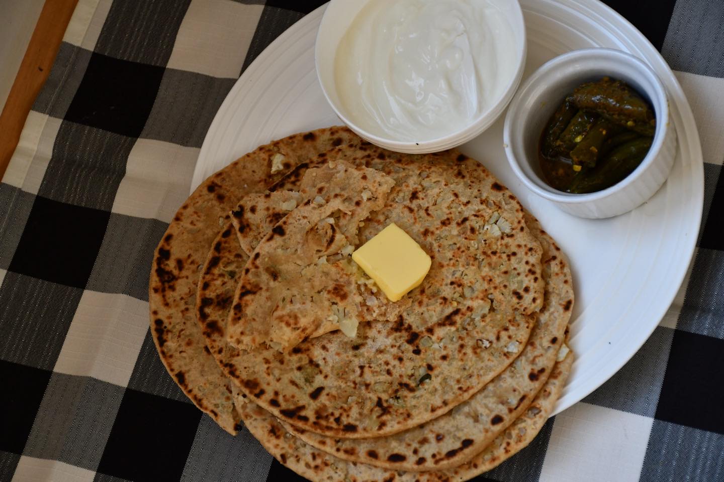 This paratha recipe is really delicious. And it tastes amazing#gobhiparatha#paratha#indianbread#dhai#pickle#brunchtime#anytime#easy#recipeon👇🏾
Ingredients
Makes 6 paratha on medium size
2 cup whole wheat flour
½ cup for dusting
Salt to taste
1/2 tsp red chilli powder or taste
2 green chilli- finely chopped
2 cup cauliflower grated or finely chopped
1/2 cup coriander leaves finely chopped
½ cup onions - finely chopped (optional)
⅓ cup oil for roasting
Water
Method
To make the dough, add salt to the flour and mix. Then add the oil and mix. Finally, add water and knead until the ingredients are combined.
And make a dough. If required add more water. Spread oil on the surface and cover the lid and rest for 20 minutes.
Stuffing
Take the cauliflower, green chilly, coriander, onions (if you want)salt and red chilly. Mix everything in a bowl and keep aside. Not too long. When you start, then add the spice.
Divide the dough into balls. Roll the paratha, and dust the paratha with flour to prevent it from sticking. Roll the dough to a 2 inch diameter and spread oil on it.
Add stuffing in the dough . Make a circular paratha with a 6 inch diameter. Cook both sides on a flat preheated pan and spread the oil into both sides. Cook until golden brown. Bake all parathas in the same manner. Your parathas are ready to eat!
Serve with yogurt and pickles or tea. Or butter.