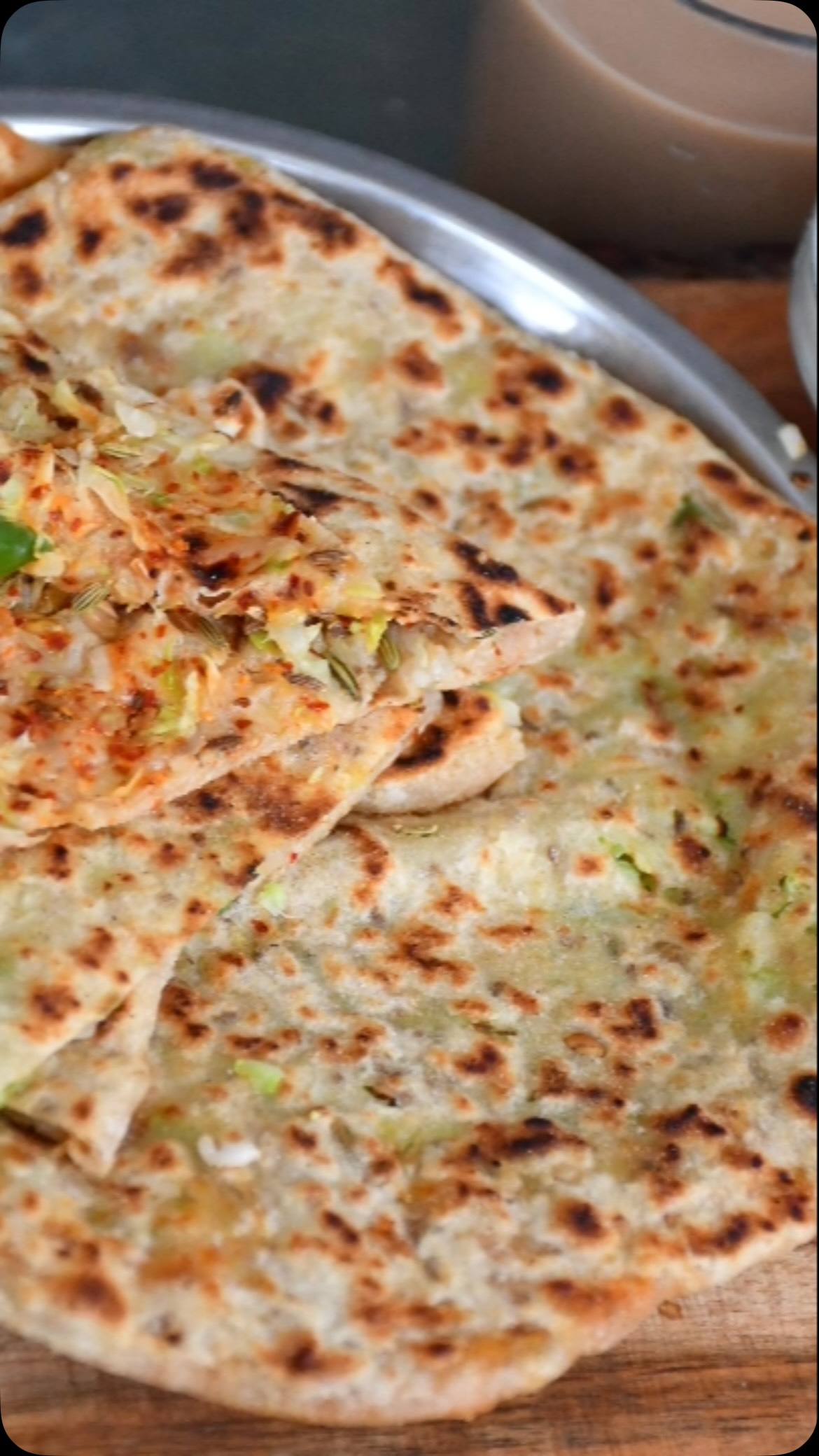 #cabbage #parathalovers #These stuffed cabbage parathas are very easy to make and healthy as well since they are packed with vegetables. They are super yummy, and ideal to take to work/school for lunch since they are just as delicious without a curry. Moreover, they’re great to sneak in vegetables for the kids since you don’t notice the cabbage.

Serves: 4 

Ingredients:
2 cups whole wheat flour - ½ cup for dusting
1 cup water 
1 tsp salt or to taste
1 tsp carom (ajwain) seeds 
Oil for roasting
For stuffing:
1 small cabbage - grated
1 small onion - finely chopped
2 green chilli - finely chopped
2 tsp cilantro - finely chopped
1 tsp red chilli powder
2 tsp salt or taste 

Method:
Take a wide dish and add flour, salt, and carom seeds. Mix together.
Add water slowly, and make soft but not sticky dough. Knead well, then cover and keep aside.
Meanwhile, add cabbage, green chilli, cilantro, red chilli powder and salt. Mix and keep aside. Add the salt when making the paratha if making in advance, otherwise the stuffing will become watery.
Put a fry pan or tawa at medium heat, and spread a little oil on it.
Make uniform balls (a little bigger than golf ball sized) of the dough. Take a piece and roll it out into a triangle shape (doesn’t need to be perfect, just generally).
In the center of the triangle, add stuffing, then fold each corner back into the center so the stuffing is inside. Roll out the dough again, but make sure it’s not too thin, otherwise the stuffing will come out.
Put the paartha on a fry pan and roast on both sides till golden brown, then spread oil on the paratha on both sides.
Serve hot or as you like with tea or curry and yogurt.
Enjoy!
Need more recipes:check my cookbook , Amazon Mudita’skitchen.