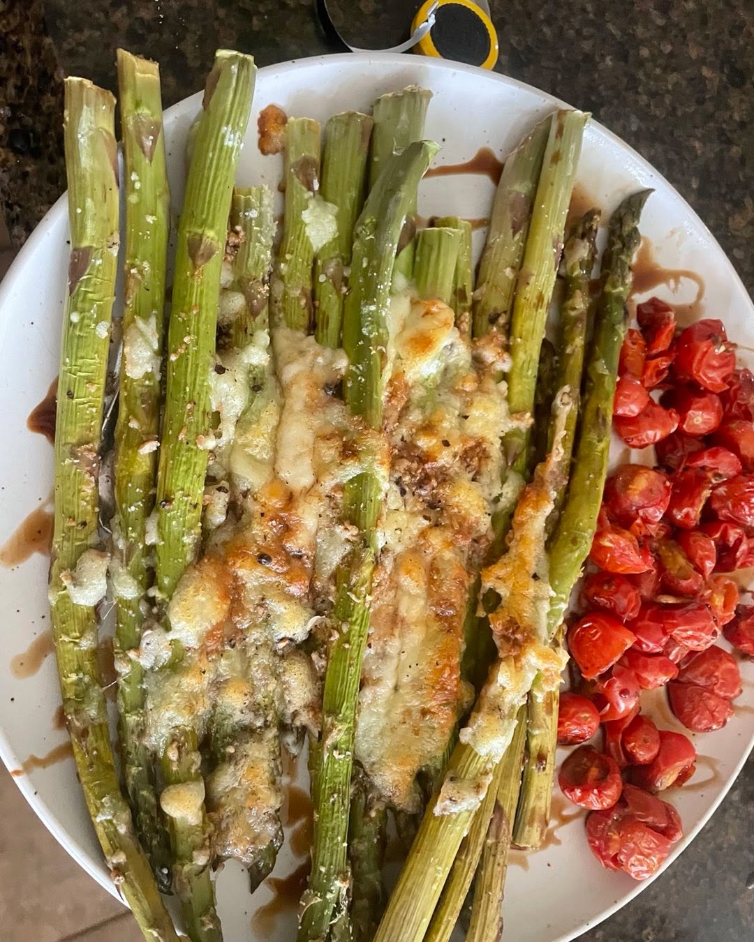 This healthy, delicious recipe is a perfect side dish! #Asparagus is very nutritious, and this is a great way to get some #vegetables in while making them taste great#baked asparagus #cherry-tomatoes#salad#recipeon👇🏾
Ingredients
12 asparagus stalks, remove bottom ½ - 1 inch
1 cup cherry tomatoes cut in halves
1 cup fresh mozzarella cheese
½ cup fresh basil - washed and cut
Salt and pepper to taste
Balsamic vinegar for garnish
Method
Preheat the oven to 375F.
Put parchment paper on a baking tray. Spread the asparagus and make sure they don’t overlap.
Add salt, pepper, and optionally garlic powder.
Spread mozzarella cheese and add a little salt and pepper (optional) to your taste.
On the side of the tray or on another spread the tomatoes and top with basil, salt, pepper, and balsamic vinegar.
Put the tray in the oven and bake for about 15 to 20 minutes or until the cheese is melting.
Take a long serving tray and place the baked asparagus then garnish with balsamic vinegar. Place tomatoes on the side.
Enjoy with bread! This goes great with toasted crusty bread like baguette. You can spread the tomatoes on top, and avocado goes well on it too.