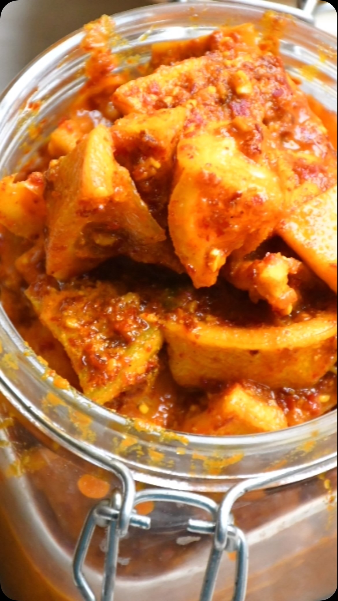 #lemon#pickle#Most of the pickles in the market are made with oil and have a thick layer of oil, which helps preserve the pickle.  I like my lemon pickle made without any oil. I used an old family recipe that has been passed down by my grand mom. The beauty of this pickle is enhanced by the “no-oil” factor and can be stored for years.

Ingredients- 6 lemons (12 if they are smaller) 
½ Cup salt
¼ Cup red chilli powder 
 ½ Cup sugar 
 3 tsp turmeric powder
 1 tsp methi seeds (Fenugreek seeds)
 1 tsp black mustard seeds 
¼  tsp hing powder (Asafoetida)
 Juice of 1 lemon (2-3 if smaller)
Large glass jar, approx 2 liters or ½ gallon

Method

Take a sharp knife  and cut the lemons, 1 lemon is 8 piece
Then, take a fry pan and add methi seeds, mustard seeds and hing, then roast on slow heat  for about  3 minutes.
Now, grind above into powder 
Take a big wide bowl and mix salt, red chilly, sugar,  turmeric powder and methi powder(mustard,hing) prepared above
Add lemon pieces to the bowl and mix so that spice coats all the pieces 
Transfer the bowl content to the jar. Make sure jar is totally dry without any moisture 
Mix and add lemon juice.
Close the lid and mix the lemon with spice
Now, keep in the sun for about 15 days - 30 days depending on weather and sun intensity till lemos are tender. If required, add more lemon juice
Pickle is ready to eat. Store it in an airtight container. Will last 1 year or more depending on conditions.