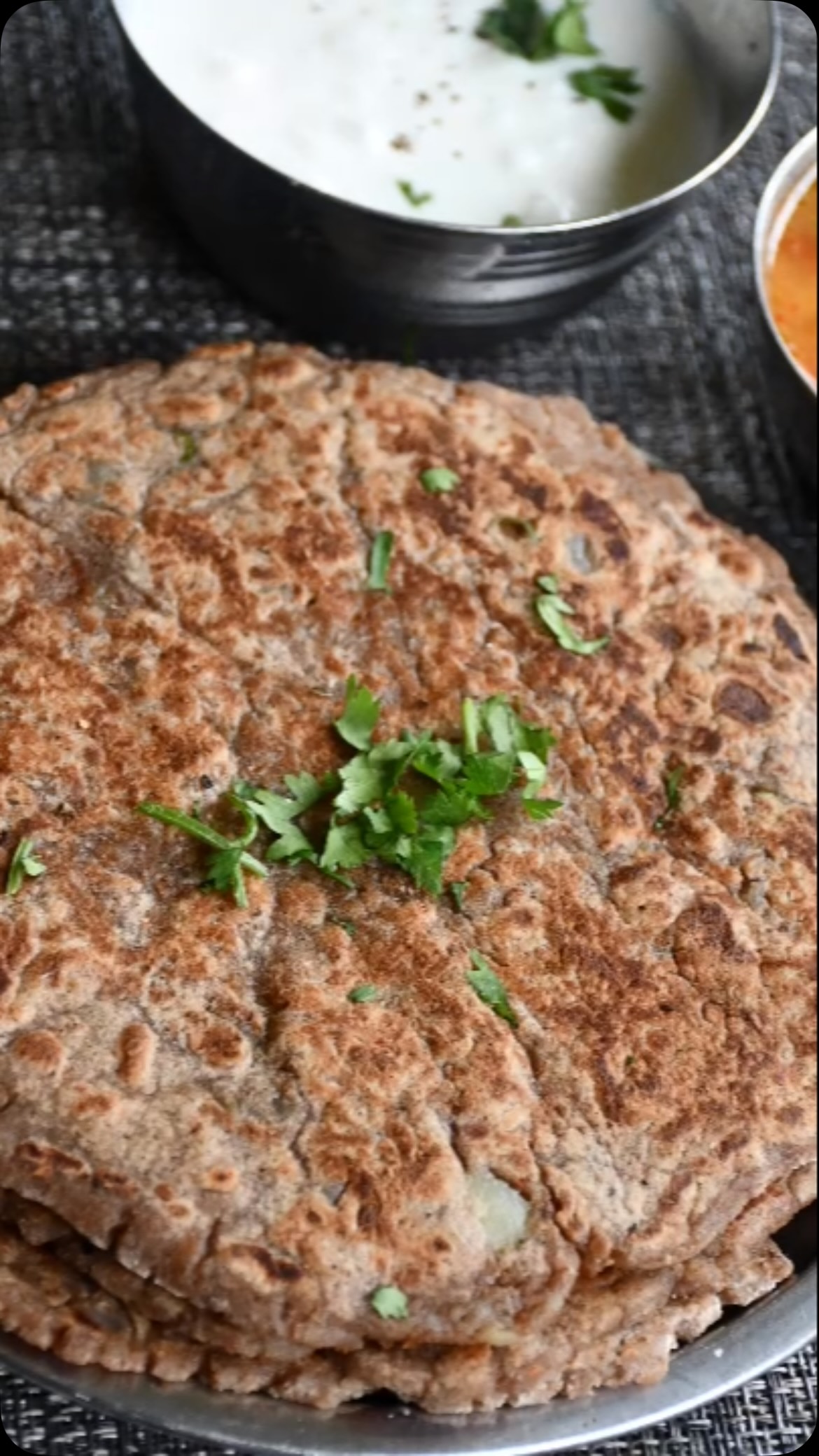 #great recipe for Navratri , all those who are fasting need light and satisfying food; here’s a great option. Or anytime. It’s gluten free#recipeon👇🏾#Happy Navratri 🙏💐

Ingredients
Make 7 to 8 medium size paratha 
2 cup singhara atta + cup dusting 
2 medium potato - boiled, mashed
2 green chilly or to taste - finely chopped 
1 tsp black pepper or to taste 
1 tbsp coriander leaves
Salt to taste
Oil for roasting

Method
First, take a wide bowl. Add atta, salt, green chili, potato, coriander leaves and black pepper. Mix, and add water if required, and make a normal dough.

Take a flat pan and put on the gas at slow heat. Divide into uniform sized pieces.  After that, take one piece of dough and roll with dust (similar to a tortilla) and avoid sticking. If it does stick to the rolling pin, take the parantha off with a spatula. When the pan is heated, put some oil in it.

Put the paratha on the pan, cook it on both sides, and spread oil on both sides.

Roast both sides until golden brown.
Enjoy with aloo sabji , lauki raita and green chutney.