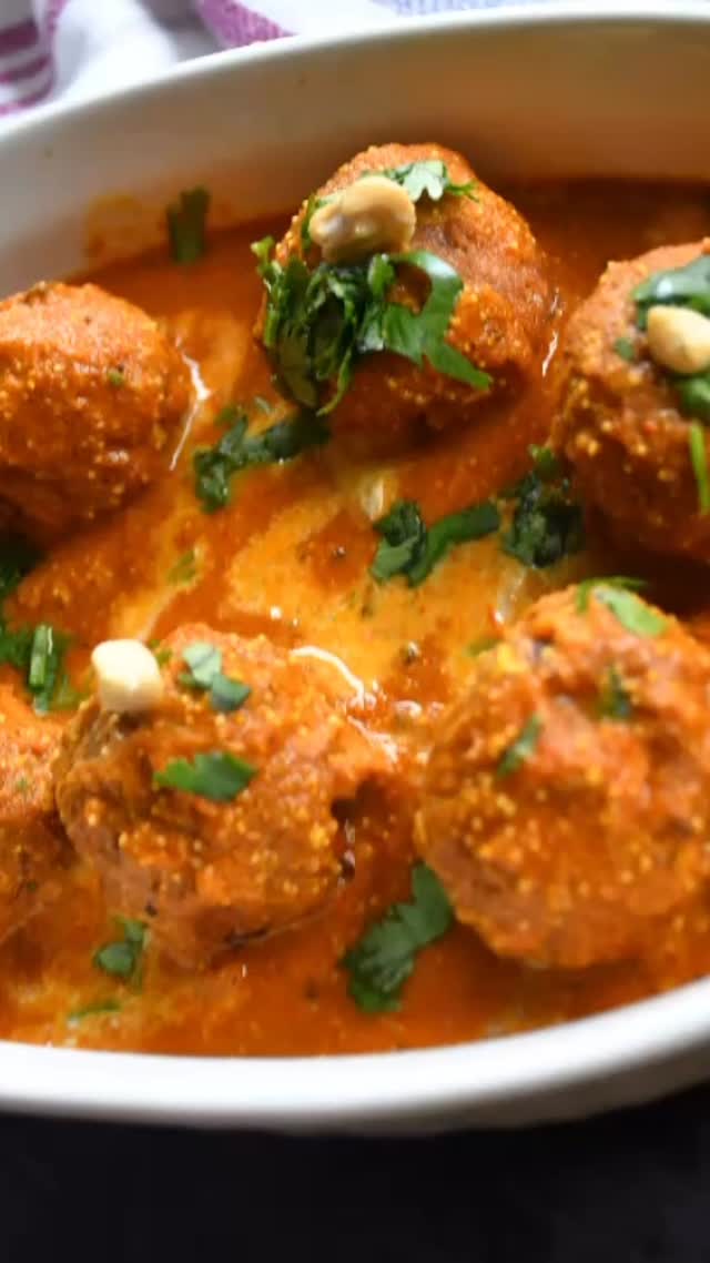 #paneer#kofta#Ingredients#super yummy and rich curry details on my website.
Serves 4 
1 small carrot -grated
1/2 tsp  cashews (optinol) 
½ tsp raisins
1 cup paneer - grated
1/3 cup peas - steamed and mashed
1 or 2 green chillies -  finely chopped
1 tsp coriander leaves - finely chopped
1 medium size potato - boiled 
2 tbsp all purpose flour or corn flour 
1/2 tsp Chaat masala 
1/2 tsp Garam masala 
2 cup oil
Gravy:
2 tsp poppy seeds - soak for ½ hour and then make a paste in a blender 
2 tsp cashews soak and blend 
1 medium size onion-grated-
2 medium sized tomatoes-grated
1 tsp ginger paste
1 tsp green chilli - finely chopped
1/2 tsp cumin seed
1 tsp Garam masala
1 tsp red chilli powder or to taste 
1 tsp turmeric
Salt - to taste
2 tsp coriander powder
1 tbsp oil
1 cup water
Method
First take a large dish, and mix the paneer, all purple flour or corn flour,salt (to your taste) and garam masala. Take another bowl and mix together the carrot, peas, coriander leaves, potatoes,salt (to your taste), chat masala and garam masala. ( or just add everything in a bowl mix and make kofta)Use your palm and stretch the paneer into flat discs, with a diameter of about an inch or two. Take an equal amount of the carrot mixture and keep aside.

make a round sized ball; it can be any shape or size, but I normally make golf ball shaped koftas. . Make all of the koftas in the same manner. Keep aside. about 15 minute.Take a small sized wide fry pan, fill it with oil, and put it on the stove. When there is smoke coming out of the oil, put 1 kofta in. If the kofta breaks, the oil is not ready, but it doesn’t break, continue to 
put the koftas in. Fry the koftas until they are golden brown, and keep turning them over once in a while. Keep them aside. 

Gravy:

First, take a pan and put it on the stove. Pour the oil in and when smoke starts coming out, add the cumin seeds. When the cumin seeds start crackling,  mix in the onions. Continue stirring for a minute on low heat.  After that, add the ginger and garlic paste. Mix in the  tomatoes, dry masala, red chilly, turmeric, coriander powder, and salt. Lastly, add garam masala and fresh coriander leaves.